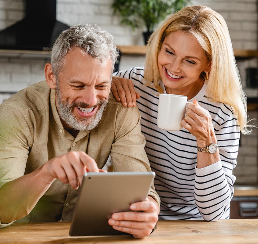 Couple looking at a tablet together in their kitchen