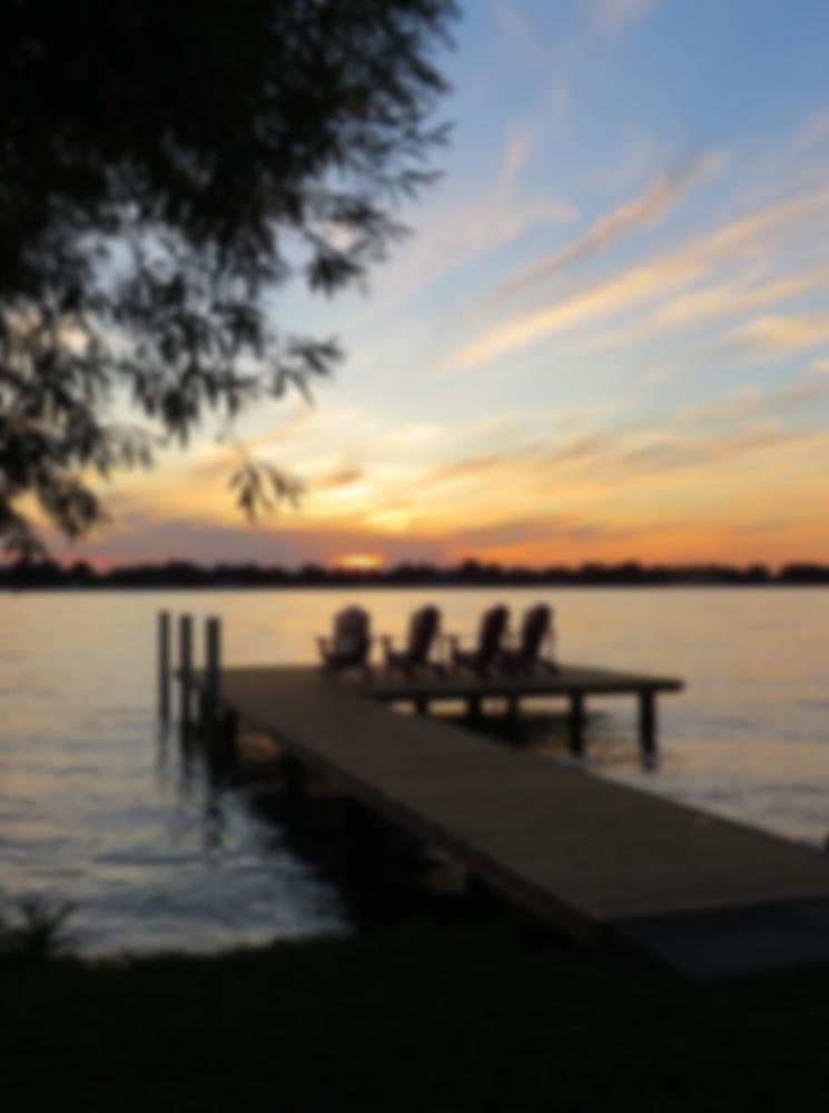 Sunset over a lake with a dock
