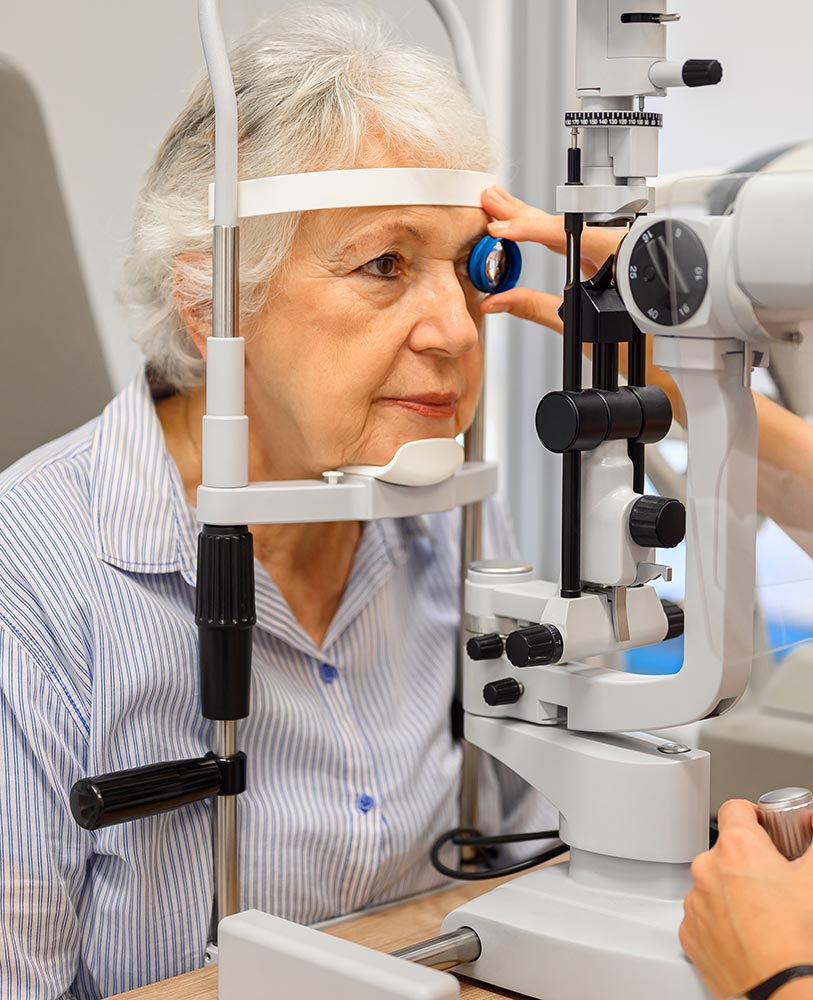 Older woman at a slit lamp during an eye exam