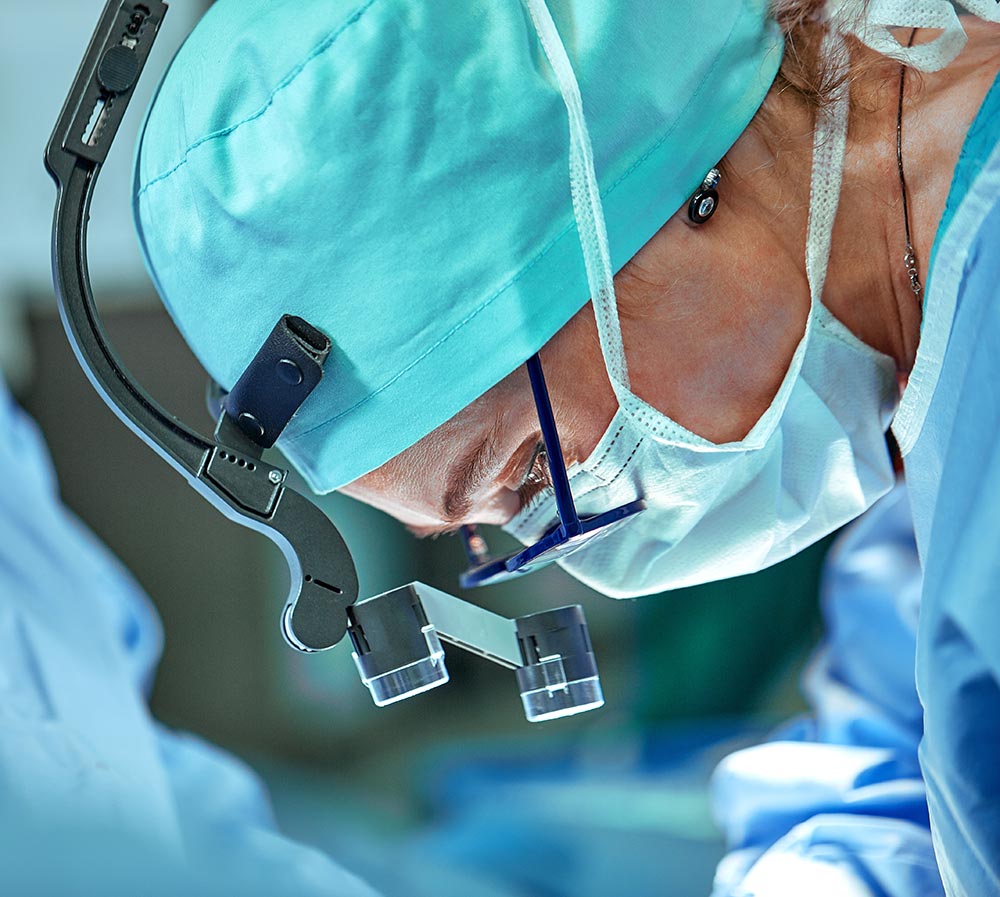 Eye surgeon performing surgery with magnifying loupes
